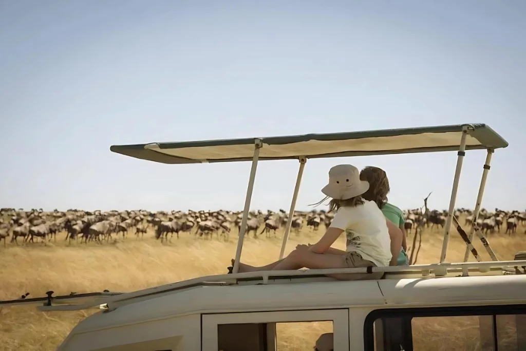 family in a safari exploring Serengeti great wildebeest migration