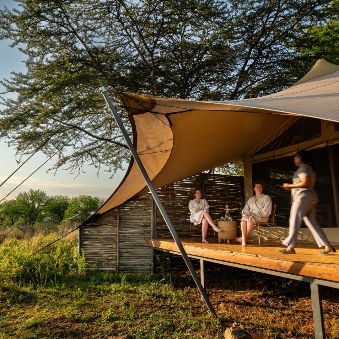 Friends relaxing on the camp veranda in the evening