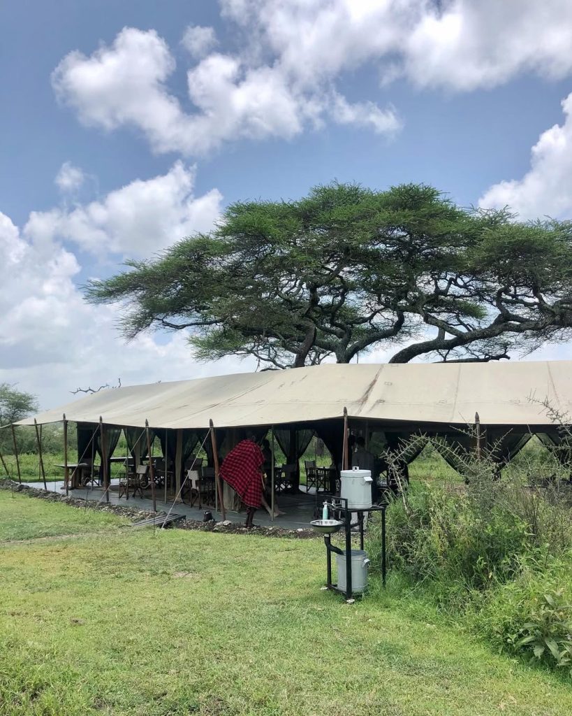 Exterior of Nomad Serengeti Safari Camp — canvas tents overlooking the Serengeti plains, Tanzania.