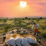 Transformative safari Tanzania 11 days — guests at a Serengeti sundowner on an East Africa Safari Guides extended stay departure