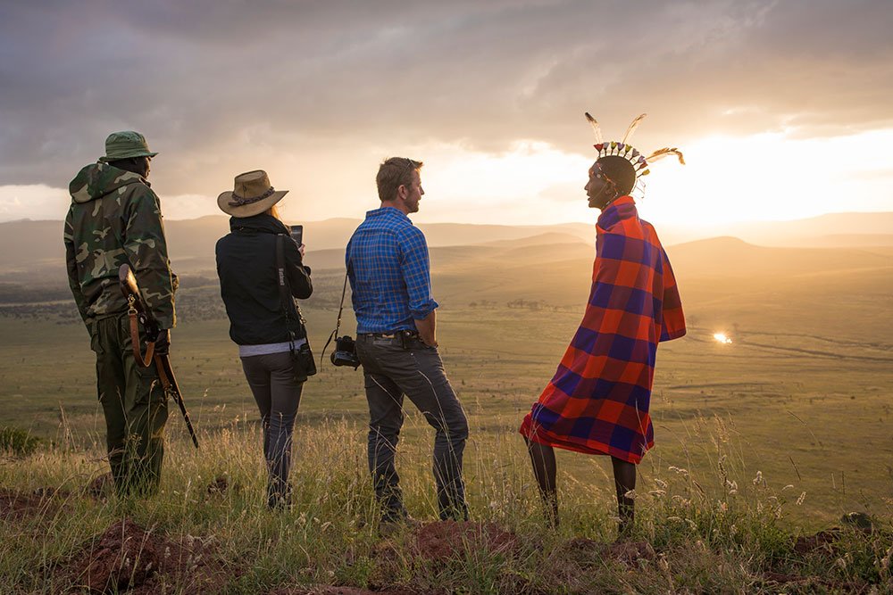 Tourist with Maasai in the heart of Serengeti