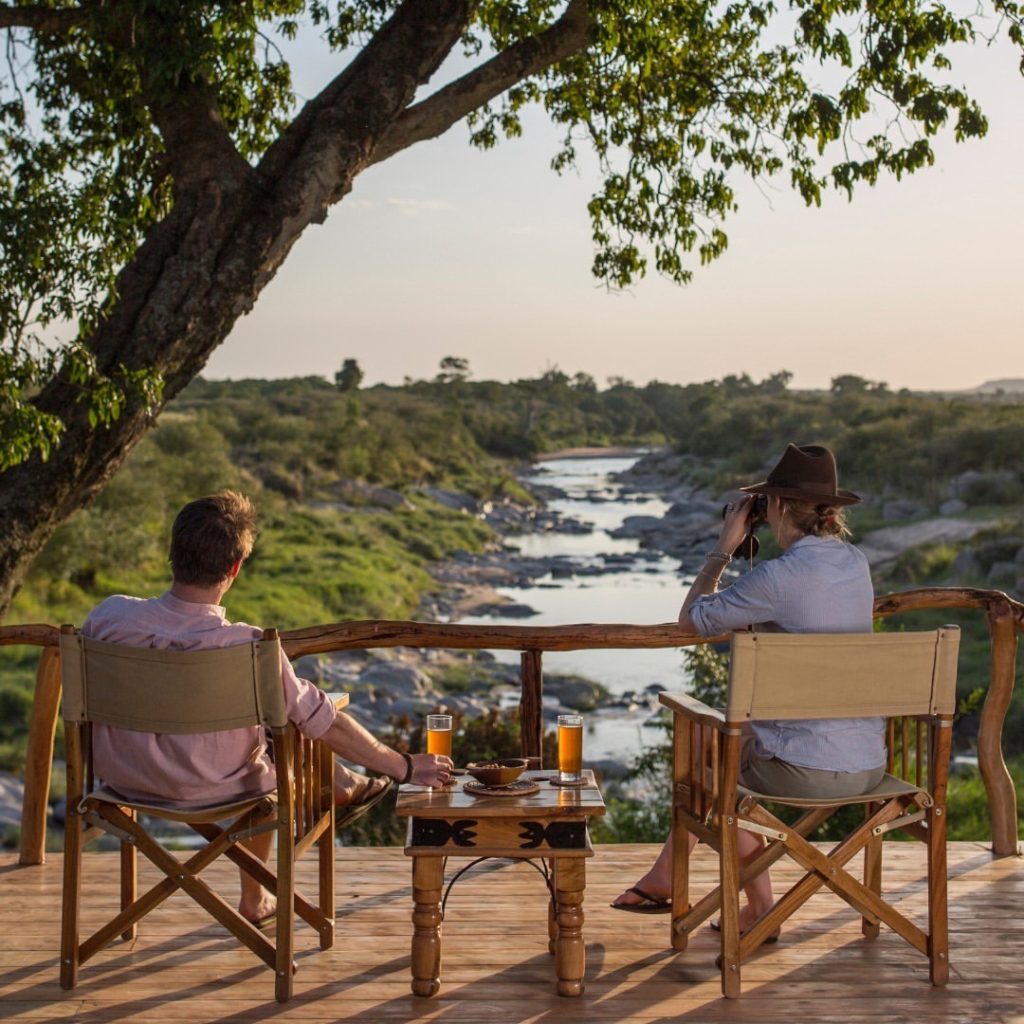 Guest experiencing a luxury Tanzania wilderness journey from a private lodge deck — East Africa Safari Guides transformative safari departure